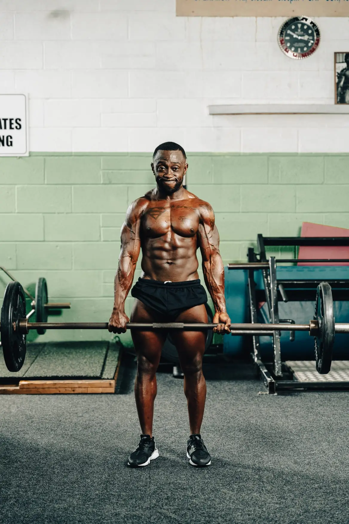 Jovan Johnson training with a loaded barbell in the gym